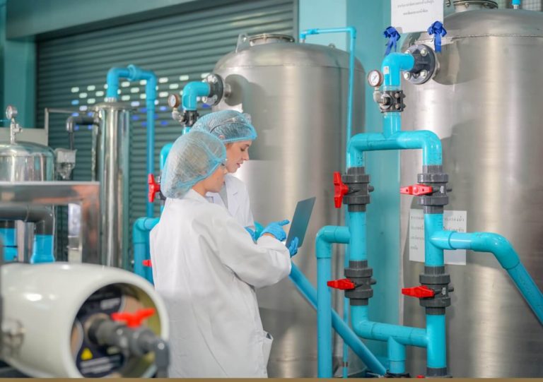 female-worker-inspecting-water-bottle-on-productio-2023-11-27-05-36-34-utc