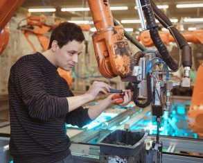 technical-worker-performs-maintenance-robotic-arms-on-the-production-line.jpg